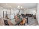 Spacious living room with an open-concept design featuring wood-look floors, dining area and kitchen at 1024 Jarrett Bay Rd, Willow Springs, NC 27592