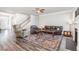 Open-concept living room featuring wood-look floors and comfortable seating at 1024 Jarrett Bay Rd, Willow Springs, NC 27592