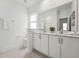 Bathroom featuring double sink vanity, a large mirror, and modern fixtures at 1425 Patchings Ln, Knightdale, NC 27545