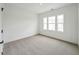 Bright, carpeted bedroom with large window, neutral walls, and ample natural light at 1425 Patchings Ln, Knightdale, NC 27545