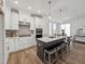 Modern kitchen featuring stainless steel appliances, a center island with seating, and elegant pendant lighting at 1425 Patchings Ln, Knightdale, NC 27545