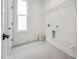 Functional laundry room with tile flooring, ample space, and a convenient wire shelving unit at 1425 Patchings Ln, Knightdale, NC 27545