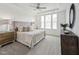 Serene main bedroom with plush carpeting, a tray ceiling, and large windows offering natural light at 1425 Patchings Ln, Knightdale, NC 27545