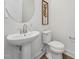 Stylish powder room featuring a pedestal sink and modern fixtures, complemented by tasteful decor at 1425 Patchings Ln, Knightdale, NC 27545