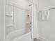 Clean, bright shower-tub combination with built-in shelves and a towel rack at 1425 Patchings Ln, Knightdale, NC 27545