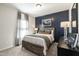 Cozy bedroom with dark-blue accent wall and wood bed frame at 180 Deodora Ln, Cameron, NC 28326