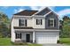 Beautiful two-story home with light siding, a dark roof, and a two-car garage at 180 Deodora Ln, Cameron, NC 28326