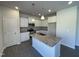 Modern kitchen features a granite island, stainless steel appliances, and white cabinets at 180 Deodora Ln, Cameron, NC 28326
