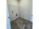 Efficient laundry room featuring tile flooring, washer hookups, and a convenient wire shelving unit at 180 Deodora Ln, Cameron, NC 28326