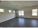Bright living room with wood-look flooring and large windows, offering plenty of natural light at 180 Deodora Ln, Cameron, NC 28326