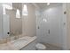 Stylish bathroom featuring a glass shower, modern vanity with marble top, and pendant lighting at 418 S Cross St, Youngsville, NC 27596