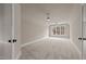 Spacious bedroom featuring a ceiling fan, neutral walls, carpet, and lots of light at 418 S Cross St, Youngsville, NC 27596