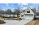 Captivating two-story home with a well-manicured lawn, a classic white garage, and ample parking at 418 S Cross St, Youngsville, NC 27596