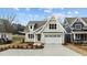 A charming two-story home featuring Craftsman architecture and a spacious driveway at 418 S Cross St, Youngsville, NC 27596