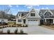 Beautiful two-story home featuring a classic white garage and a well-maintained front yard at 418 S Cross St, Youngsville, NC 27596