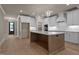 Elegant kitchen boasts a large center island, custom cabinetry, and stainless steel appliances at 418 S Cross St, Youngsville, NC 27596