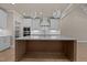Modern kitchen featuring a spacious center island, sleek countertops, and contemporary lighting fixtures at 418 S Cross St, Youngsville, NC 27596