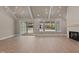 Bright and airy living room featuring hardwood floors, large windows, and a fireplace at 418 S Cross St, Youngsville, NC 27596