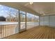 Screened patio with wood flooring, a ceiling fan, and views of backyard at 418 S Cross St, Youngsville, NC 27596