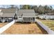 High angle view of the rear exterior featuring covered porch and open backyard at 418 S Cross St, Youngsville, NC 27596