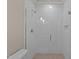 Sleek glass-enclosed shower with unique white tile pattern and neutral-toned flooring at 418 S Cross St, Youngsville, NC 27596
