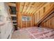 Unfinished attic space with plywood flooring, insulation and a single window at 50 N Rowsham Pl, Smithfield, NC 27577