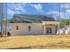Well-maintained back exterior with a covered patio, a sliding glass door, and manicured lawn at 50 N Rowsham Pl, Smithfield, NC 27577