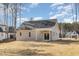 Charming back exterior featuring a covered patio, neutral siding, and a meticulously maintained lawn at 50 N Rowsham Pl, Smithfield, NC 27577