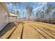 Expansive backyard with lush landscaping, tall trees, and a covered patio, perfect for outdoor gatherings at 50 N Rowsham Pl, Smithfield, NC 27577