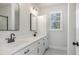 Modern bathroom with dual sinks, white cabinetry, and a large mirror at 50 N Rowsham Pl, Smithfield, NC 27577
