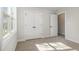 Neutral bedroom featuring a bright window, carpet, and pair of double door closets at 50 N Rowsham Pl, Smithfield, NC 27577
