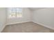 Bright bedroom with carpeted floor and a large window at 50 N Rowsham Pl, Smithfield, NC 27577