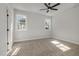 Light-filled bedroom with plush carpeting, neutral walls, and large windows at 50 N Rowsham Pl, Smithfield, NC 27577