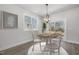 Staged dining area has a round table, elegant chandelier, and sliding glass doors at 50 N Rowsham Pl, Smithfield, NC 27577