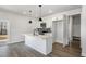 Modern kitchen features sleek white cabinets, stainless steel appliances, and a functional island at 50 N Rowsham Pl, Smithfield, NC 27577