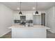 Bright kitchen with white cabinets, stainless appliances, and an island with a sink at 50 N Rowsham Pl, Smithfield, NC 27577