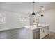 Bright, modern kitchen features white cabinets, stainless steel appliances, and quartz countertops at 50 N Rowsham Pl, Smithfield, NC 27577