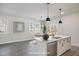 Bright kitchen showcases white cabinets, stainless dishwasher, and breakfast area nearby at 50 N Rowsham Pl, Smithfield, NC 27577
