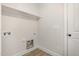 Functional laundry room with built-in shelving, washer/dryer hookups, and clean white walls at 50 N Rowsham Pl, Smithfield, NC 27577