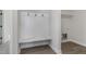 Convenient mud room with built-in bench, coat hooks, and laundry area at 50 N Rowsham Pl, Smithfield, NC 27577