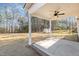 Covered patio featuring a ceiling fan, concrete pad, and brick border at 50 N Rowsham Pl, Smithfield, NC 27577