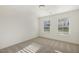 Bright bedroom with plush carpet, two windows, and modern trim at 611 Highview Dr, Benson, NC 27504