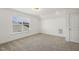 Bright, carpeted bedroom with natural light from a window and white door with trim at 611 Highview Dr, Benson, NC 27504
