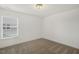 Small bedroom featuring neutral carpet, window with blinds, and base trim at 611 Highview Dr, Benson, NC 27504