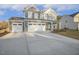 Attractive two-story home with stone accents and an attached two-car garage on a concrete driveway at 611 Highview Dr, Benson, NC 27504
