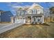 Charming two-story home boasts a stone facade, attached garage, and well-maintained lawn at 611 Highview Dr, Benson, NC 27504