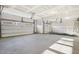 Spacious garage with two car bays, smooth concrete flooring, and installed door hardware at 611 Highview Dr, Benson, NC 27504