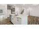 Kitchen island with quartz countertops, stainless dishwasher, and a view of the staircase at 611 Highview Dr, Benson, NC 27504