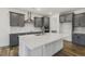 Kitchen featuring a large island, quartz countertops, stainless hood, and gray cabinetry at 611 Highview Dr, Benson, NC 27504