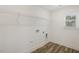 Functional laundry room with wood-look flooring and convenient wire shelving at 611 Highview Dr, Benson, NC 27504